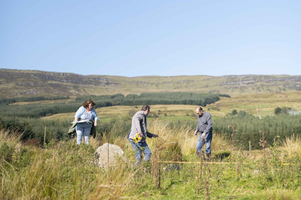 Archaeologists survey a site